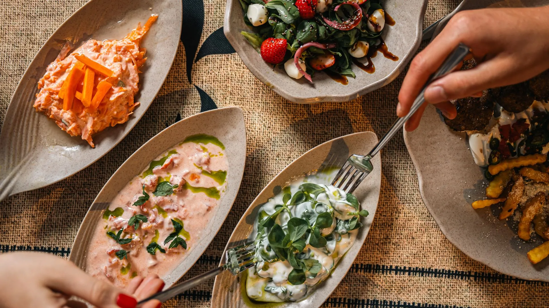 Urla mezes from above — a shared meze table on ceramic plates